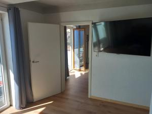a room with a large flat screen tv on a wall at Privatunterkunft Kaning in Kaning