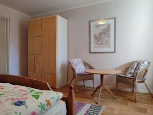 a bedroom with a bed and a table and chairs at Viol in Filipstad