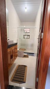 a bathroom with a shower and a sink and a toilet at Refúgio no Interior in Domingos Martins +14 photos