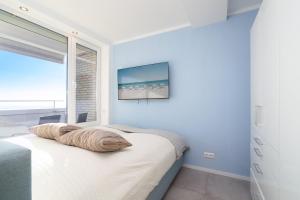 a bedroom with a bed with a television on the wall at Panoramic App B07-1 in Sierksdorf