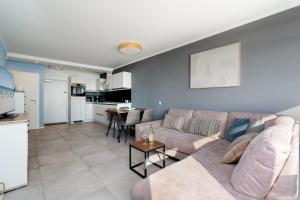 a living room with a couch and a table at Panoramic App B07-1 in Sierksdorf