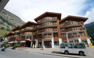 a building with a white van parked in front of it at ZermHaus - in the village center - very comfortable in Zermatt