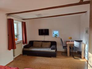 a living room with a couch and a table at Pension Pastoriushaus in Bad Windsheim