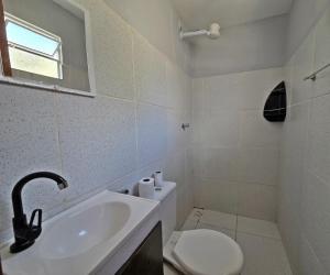 a white bathroom with a sink and a toilet at Pousada SolMaris in João Pessoa +17 photos