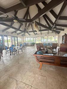 a large room with tables and chairs and a piano at The Flip Flop Villa in Christiansted