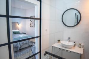 a bathroom with a sink and a mirror at NamibStay Swakop Self Catering in Swakopmund