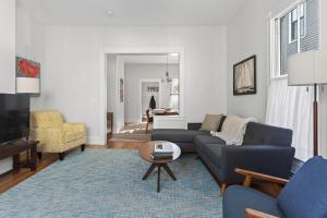 a living room with a couch and a table at Modern West End Townhome 3BR 2BA in Portland