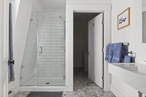 a bathroom with a glass shower and a sink at Modern West End Townhome 3BR 2BA in Portland +38 photos