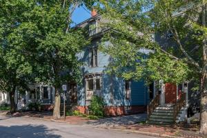 a blue house with trees in front of it at Modern West End Townhome 3BR 2BA in Portland