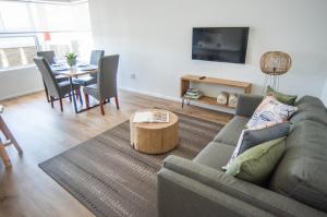a living room with a couch and a table at NamibStay Swakop Self Catering in Swakopmund