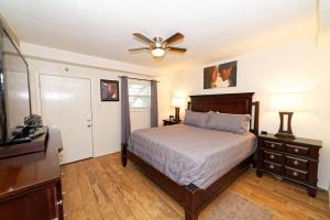 a bedroom with a bed and a ceiling fan at Captain Jacks Pearl in Port Aransas +31 photos