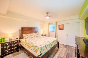 a bedroom with a bed and a dresser and a window at Five O Clock Somewhere in Port Aransas +35 photos