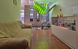 a living room with a couch and a glass case at Pousada SolMaris in João Pessoa