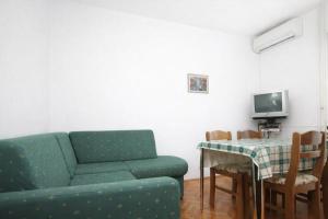 a living room with a couch and a table at Apartments in Turanj 150 meters from the sea - By TA Leut Agency in Turanj