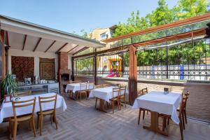 a restaurant with tables and chairs on a patio at April Mansion in Istanbul