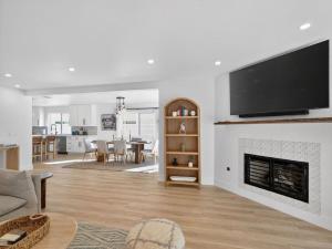 a living room with a fireplace with a flat screen tv at Outrigger Beach Retreat in Oxnard