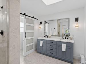 a bathroom with a sink and a mirror at Outrigger Beach Retreat in Oxnard +23 photos
