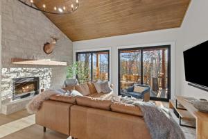 a living room with a couch and a fireplace at Highland House in Banner Elk