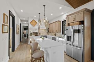 a kitchen with a white counter and a refrigerator at Highland House in Banner Elk
