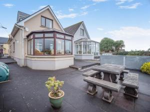 a patio with a table and a bench and a house at 3 Bed in Dingle oc-ii05995 in Dingle