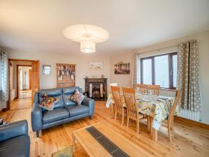 a living room with a couch and a dining room table at 3 Bed in Dingle oc-ii05995 in Dingle