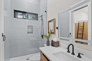 a white bathroom with a sink and a mirror at Highland House in Banner Elk +67 photos