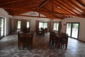 a dining room with wooden tables and chairs at Complejo Sol y Sombra in San Javier