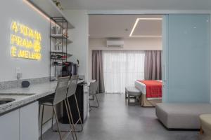 a room with a kitchen and a bedroom with a bed at Japaratinga Lounge Resort - All Inclusive in Japaratinga +52 photos