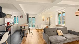 a living room with a couch and a table in a kitchen at Le Duplex in Valence