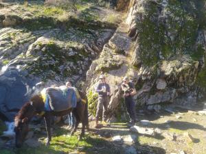 a group of people standing next to a horse on a mountain at Sidi hssain in Marrakesh +7 photos