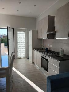 a kitchen with stainless steel appliances and a dining room at Grazia Nest in Ciampino