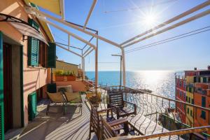 a balcony with chairs and a view of the ocean at Ca da maina in Riomaggiore