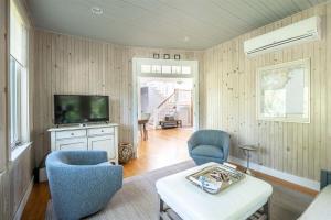 a living room with two chairs and a tv at Starboard in Kennebunk