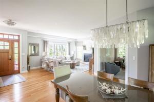 a living room with a table and a dining room at Starboard in Kennebunk