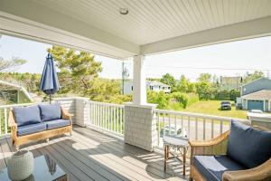 a porch with two chairs and an umbrella at Starboard in Kennebunk