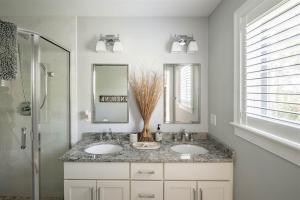 a bathroom with two sinks and a shower at Starboard in Kennebunk +37 photos