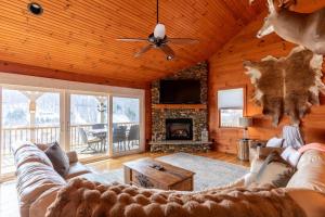 a living room with a couch and a fireplace at Rosey Outlook in Boone
