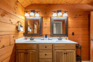 a bathroom with two sinks and two mirrors at Rosey Outlook in Boone +37 photos