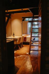 a room with a bed and a table and a ladder at Canaã Cabanas in Mariópolis