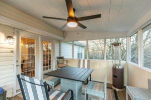 a porch with a table and chairs and a ceiling fan at Our Happy Nest in Boone