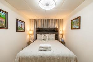 a bedroom with a bed and two pictures on the wall at Our Happy Nest in Boone