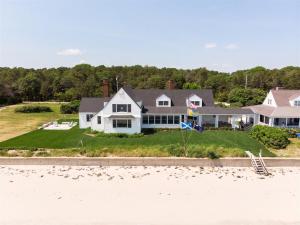 a house on the beach with a flag on it at Nautilus Beach House in Kennebunk