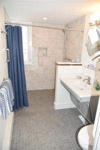 a bathroom with a sink and a toilet and a shower at Nautilus Beach House in Kennebunk +33 photos