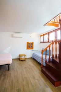 a bedroom with a bed and stairs in a room at Ca da maina in Riomaggiore
