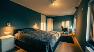 a bedroom with a bed and a desk with a chair at GT Nord Hof in Müllenbach