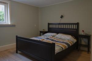 a bedroom with a bed and two night stands at Bij Ons Achter in Biggekerke
