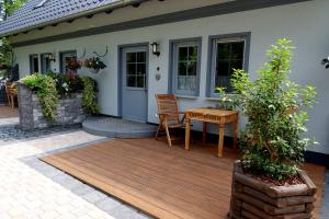 a deck with a table and chairs on a house at Ferienwohnungen Ast in Burg