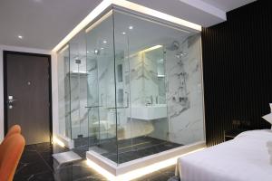 a bathroom with a glass shower with a sink at Stylish Condo Near Nai Harn Beach Full Facilities Utopia M720 in Rawai Beach