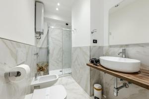 a bathroom with a sink and a toilet and a shower at Le Colonne Di San Luca Affittacamere in Genoa +31 photos