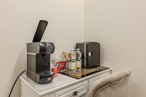 a table with a coffee maker and a microwave on it at Le Colonne Di San Luca Affittacamere in Genoa